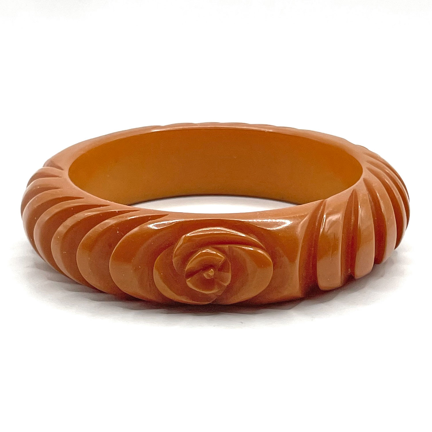 Carved orange bakelite bangle