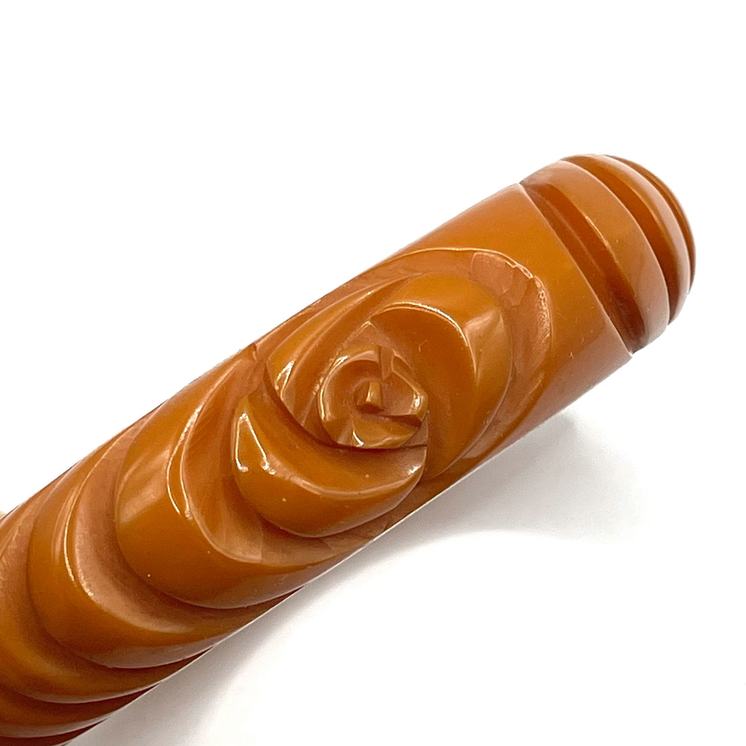 Carved orange bakelite bangle