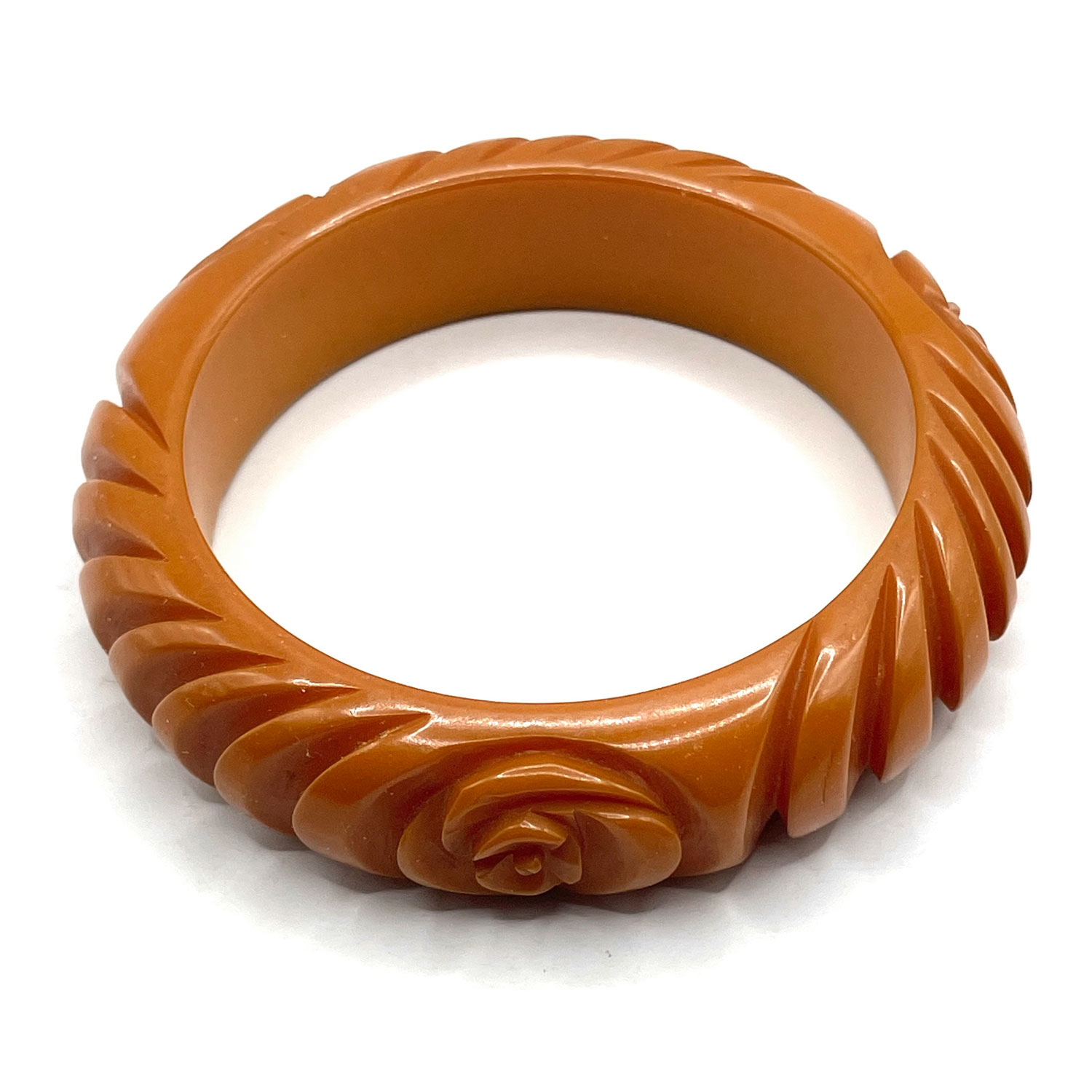 Carved orange bakelite bangle