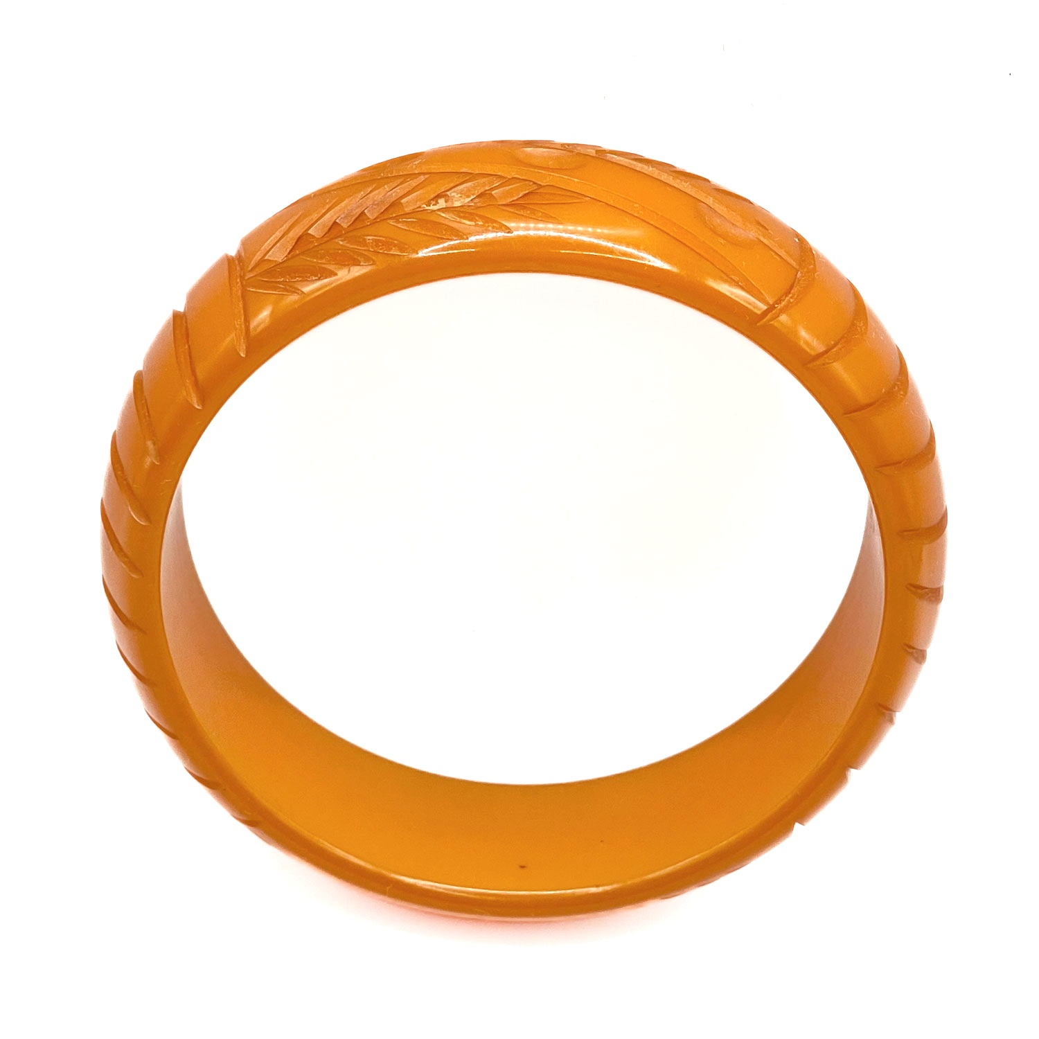 Carved orange bakelite bangle