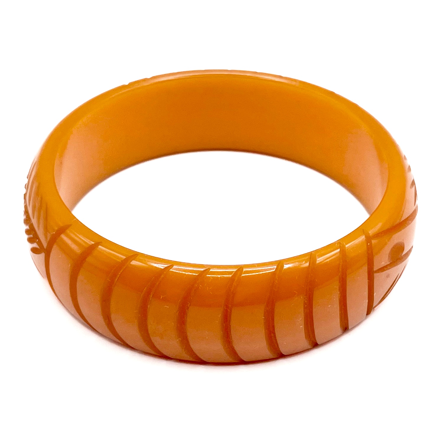 Carved orange bakelite bangle