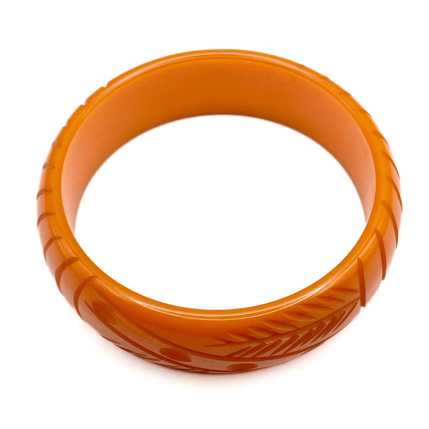 Carved orange bakelite bangle