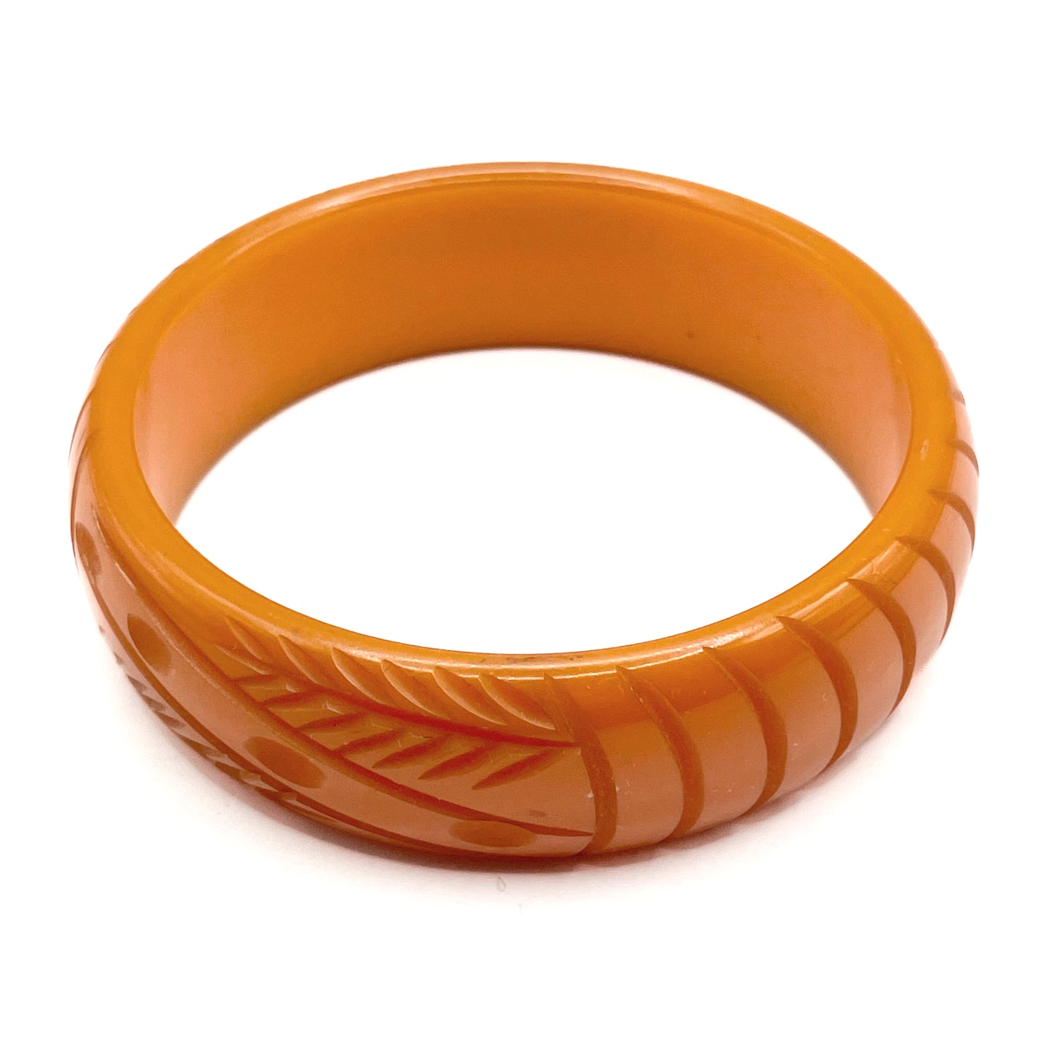 Carved orange bakelite bangle