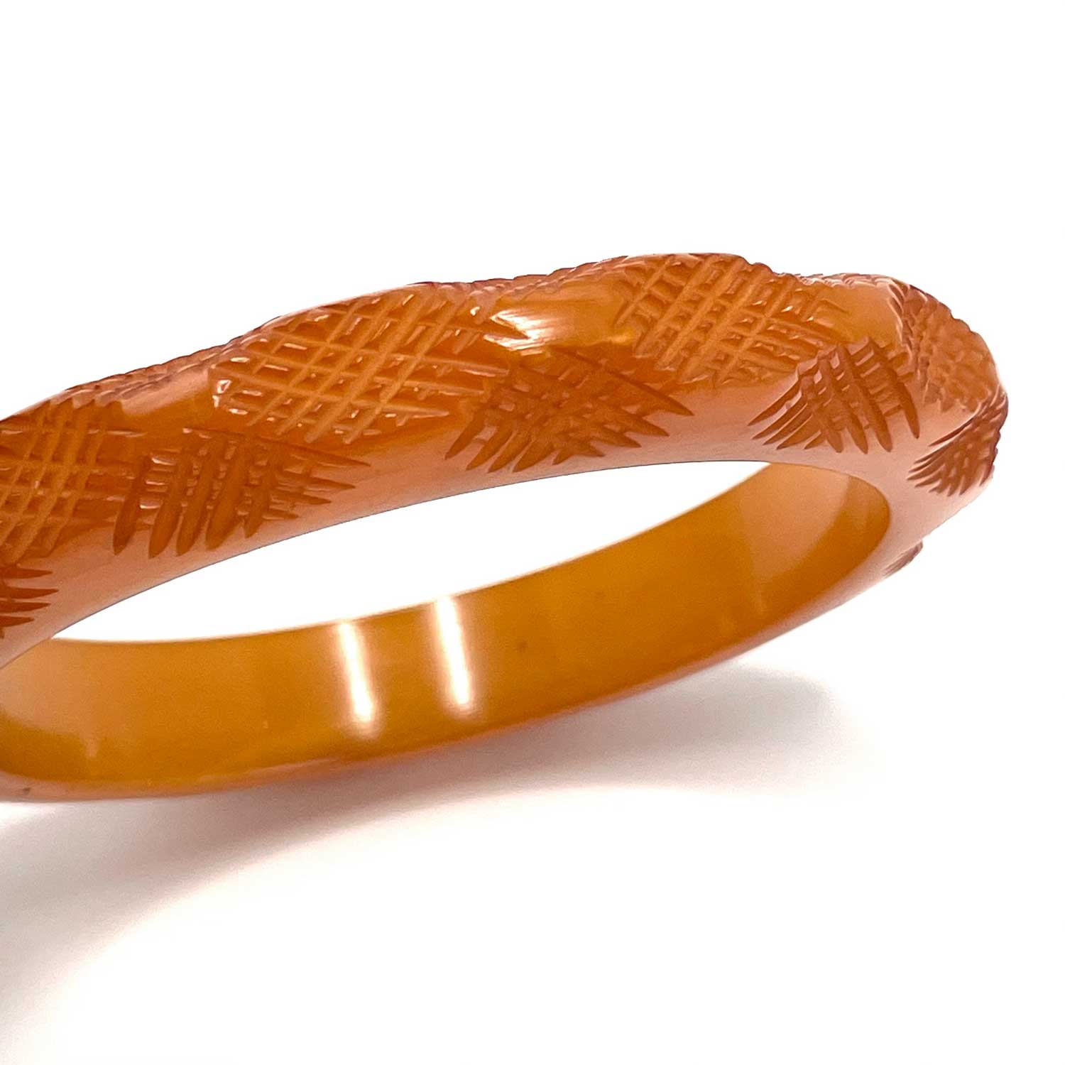 Carved burnt orange bakelite bangle