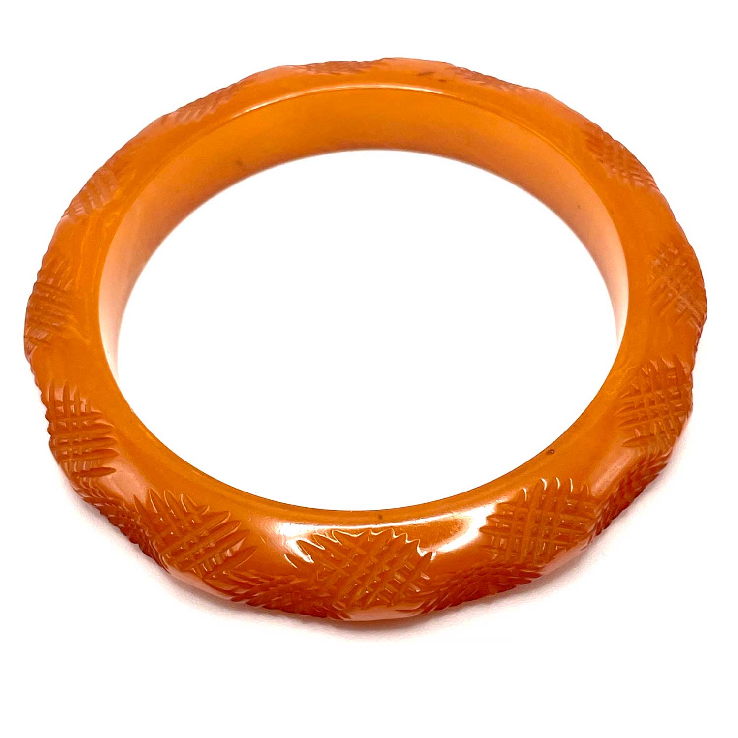Carved burnt orange bakelite bangle