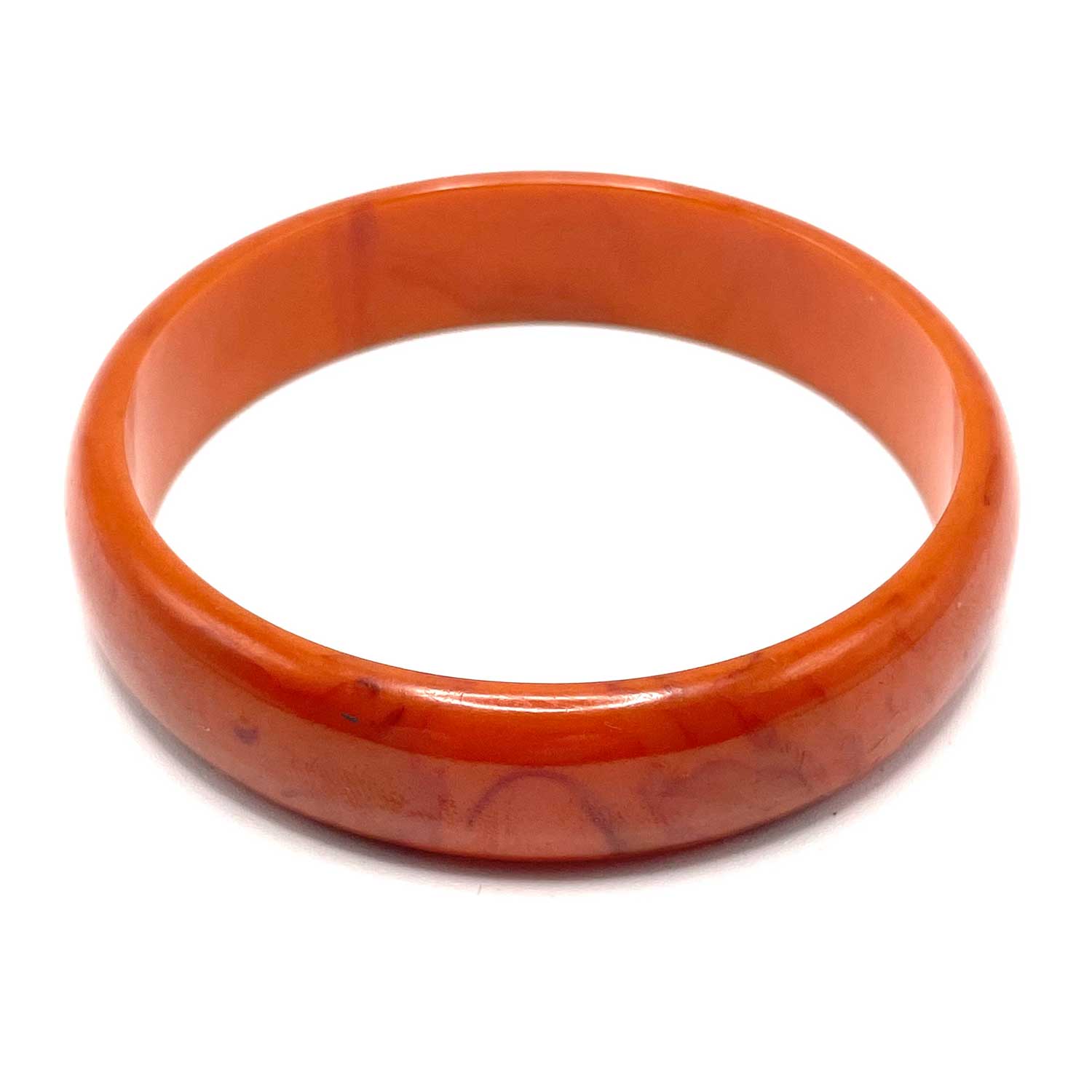 Carved orange swirl bakelite bangle