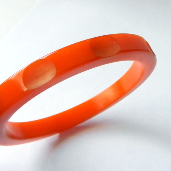 Carved orange bakelite bangle