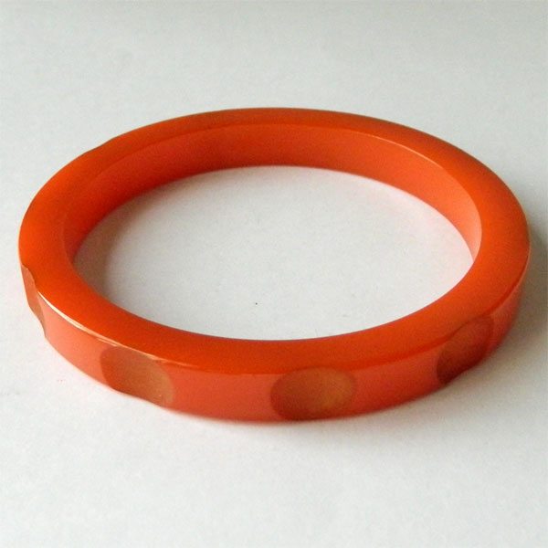 Carved orange bakelite bangle