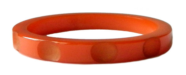 Carved orange bakelite bangle