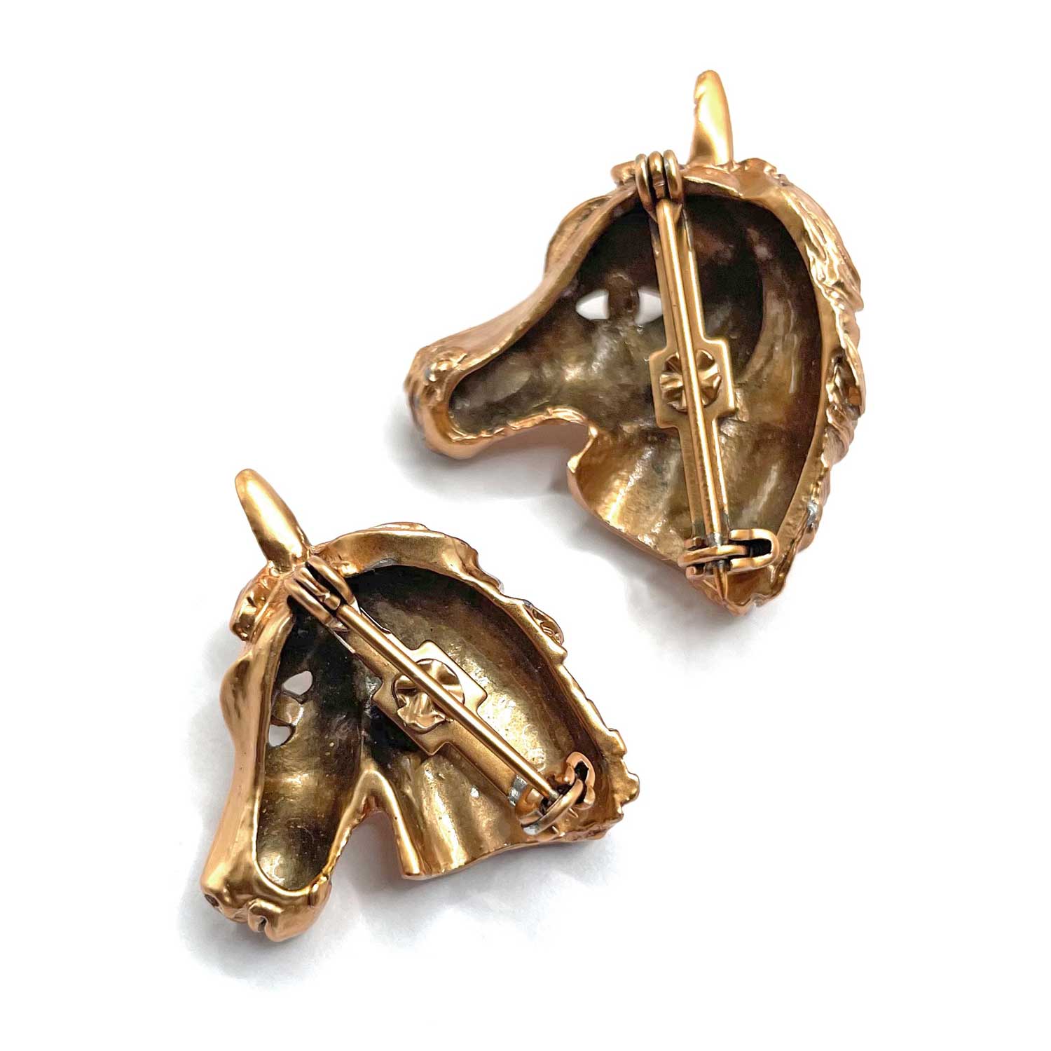 Pair of horse head brooches