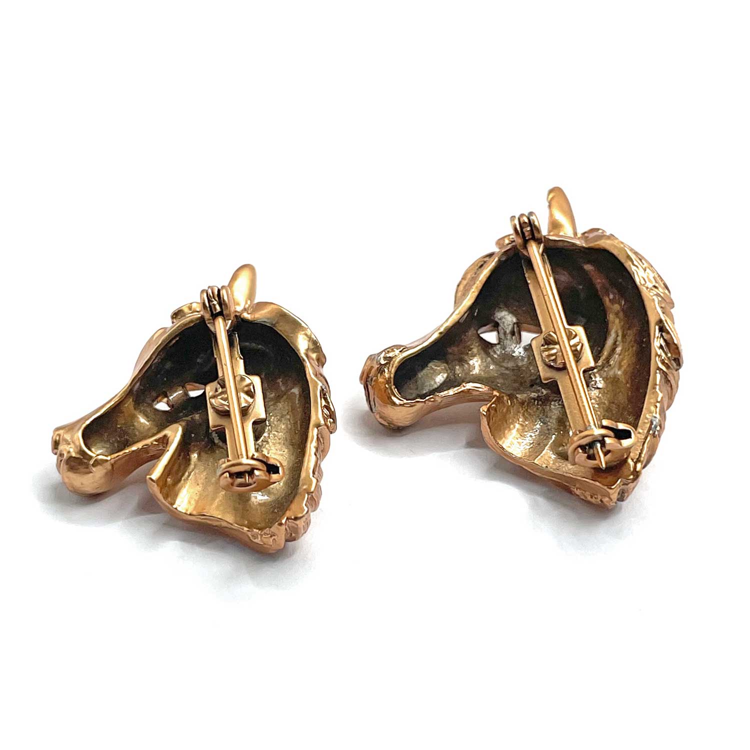 Pair of horse head brooches