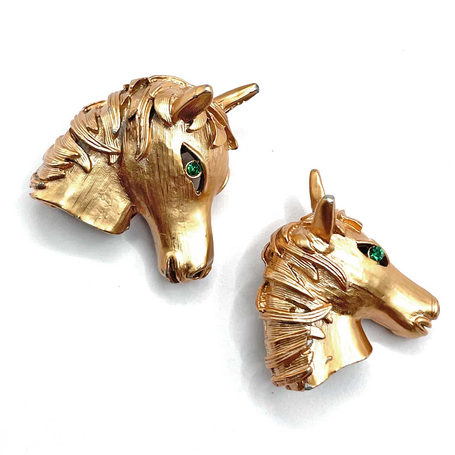 Pair of horse head brooches